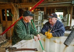 Elma farmer Jay Gordon chats with longtime friend Neal Lucht, 55, in the farm's grainery recently after the pair enjoyed homemade sourdough bread for breakfast. Lucht, who lives in Molalla, Ore., was visiting Gordon to obtain some grain to bring back home.