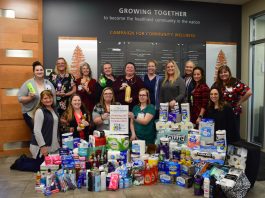 Summit Pacific's employee-led Spirit Team posing with the toiletries they donated to the Elma High Schools Food Bowl and Toiletry Drive