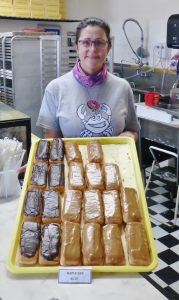 Ocean-Shores-Donuts-Owner-Robyn-Holt-with-a-Tray-of-Maple-Bars