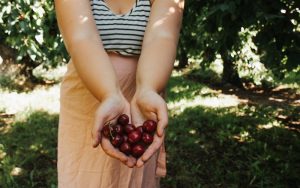 Britta Jackson holding cherries in her hand