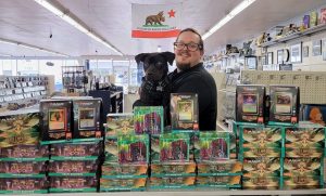 Lion Gaurd Gaming owner Terry posing with his dog Jax around minatures
