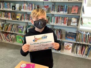 Patron Daniel Bundy shows off his Timberland Regional Library Summer Library Program Certificate of Completion
