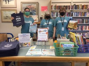 Timberland Regional Library staff by a table full of books