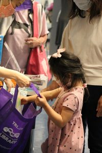 A mother and daughter look over materials in a Take-'N-Make bag at West Olympia Timberland Regional Library