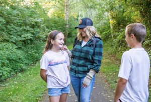 a women and two kids stand in the forest at Friends Landing in Grays Harbor