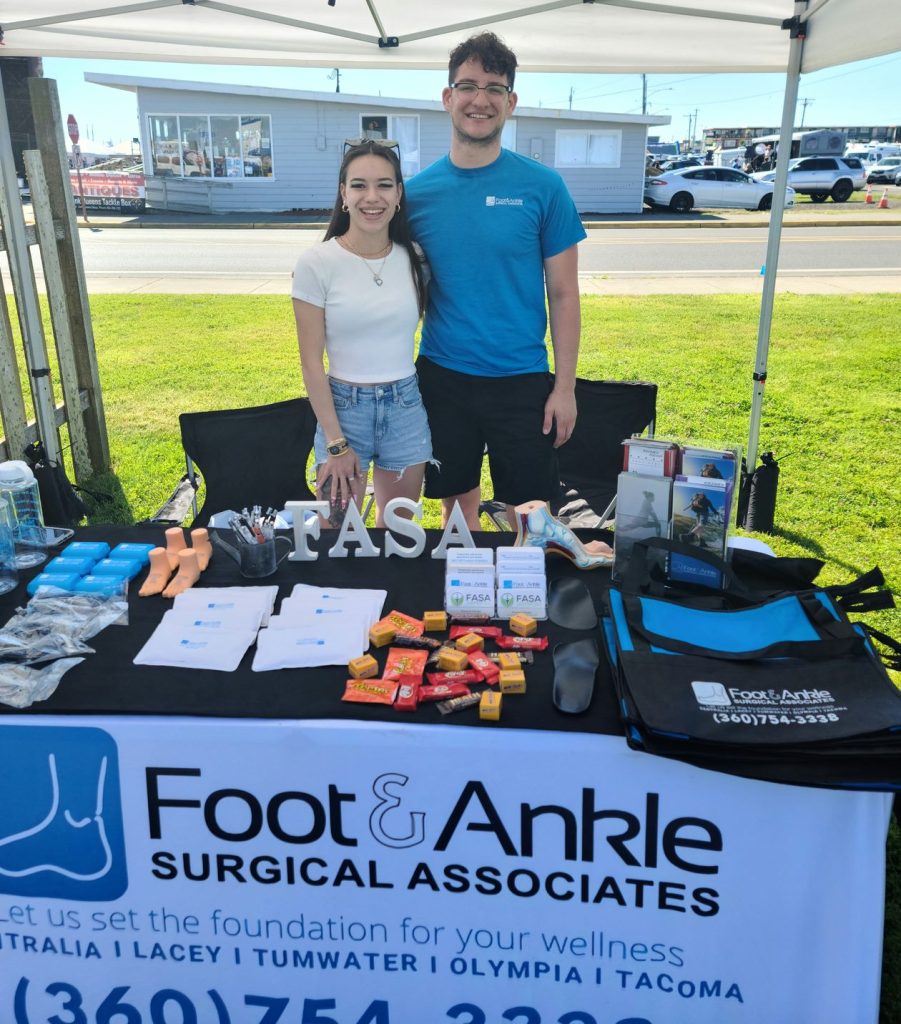 Jayden and Mikele of FASA standing together in a Foot & Ankle booth