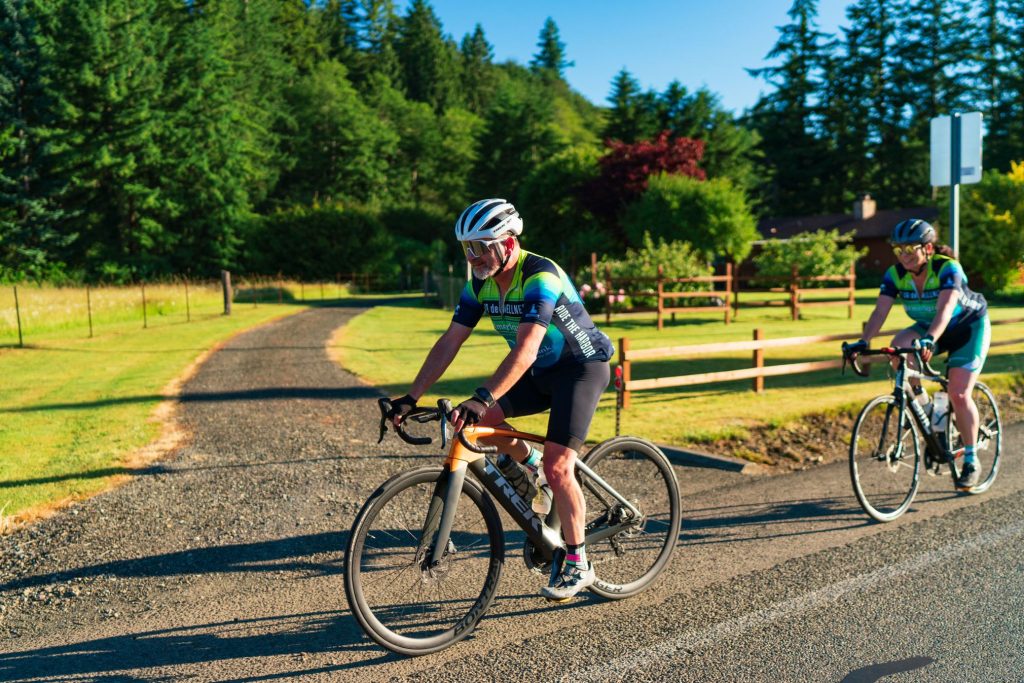 people riding bikes on a road