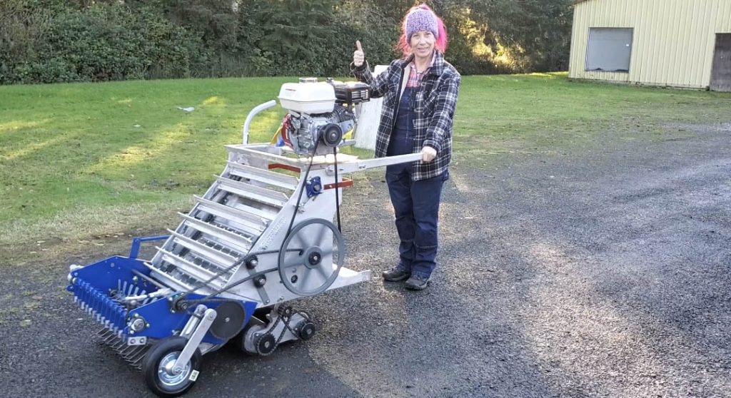 Holly Marshall standing with her cranberry picker