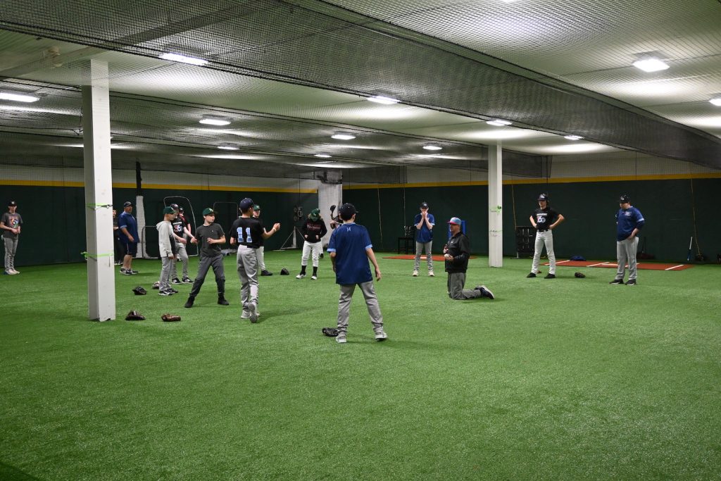 group of kids practicing baseball indoors at Multisport 360
