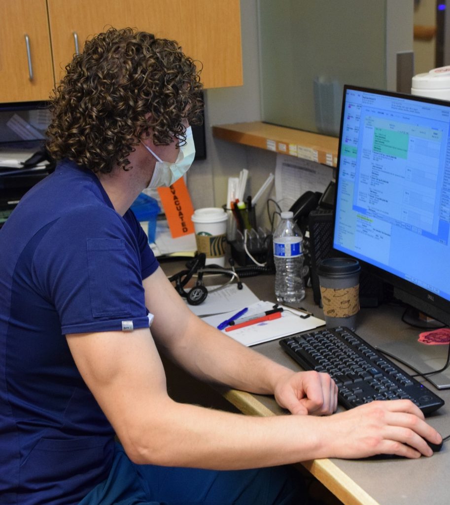 nurse sitting at a computer