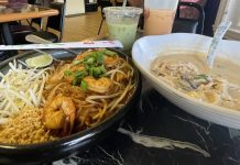 plate of pad thai, bowl of some type of thai soup with two boba tea drinks in the background