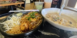 plate of pad thai, bowl of some type of thai soup with two boba tea drinks in the background