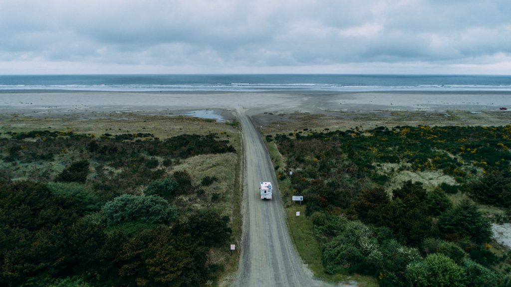 camper heading towards a beach to drive on it