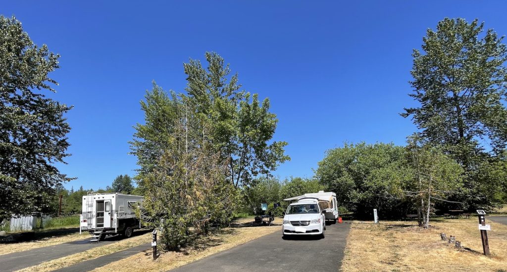 cement rv pads with trees between. Car and RVS parked in both
