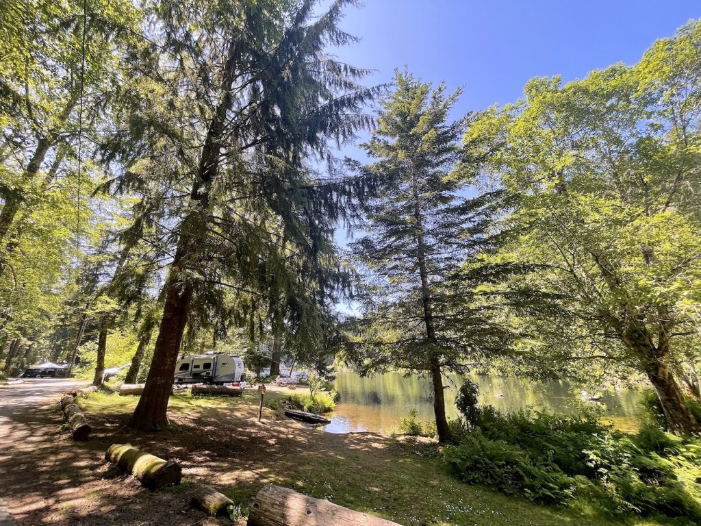 wooded campsites with an rve and a tent in the distance