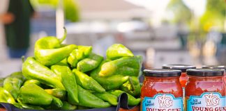 large bowl of green chilies next to a jar of salsa