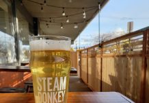 a glass of Steam Donkey beer sitting on a wooden table