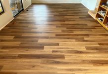 photo of an empty room with a textured vinyl plank floor that looks like wood