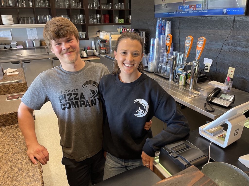 Mary Davis and John Buck pose for a photo behind the counter at Westport Pizza