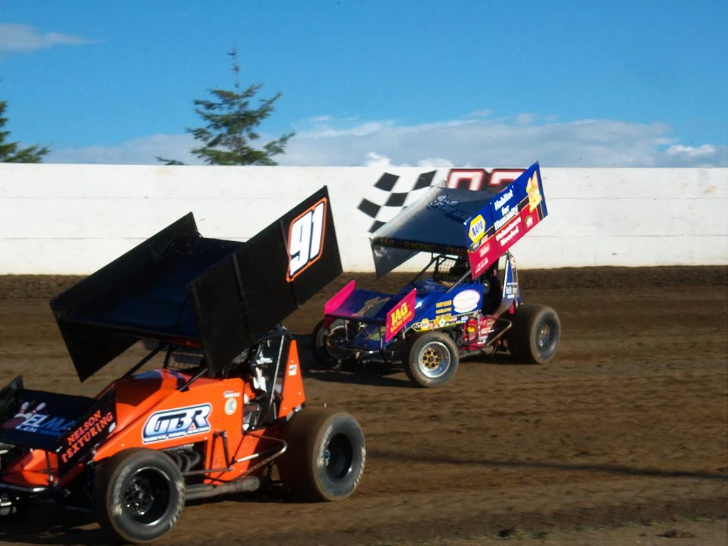 two race cars on a dirt track