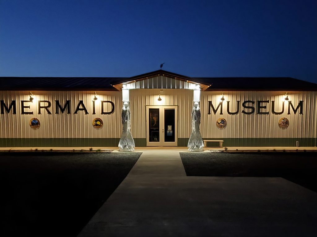 International Mermaid Museum building lit up at night