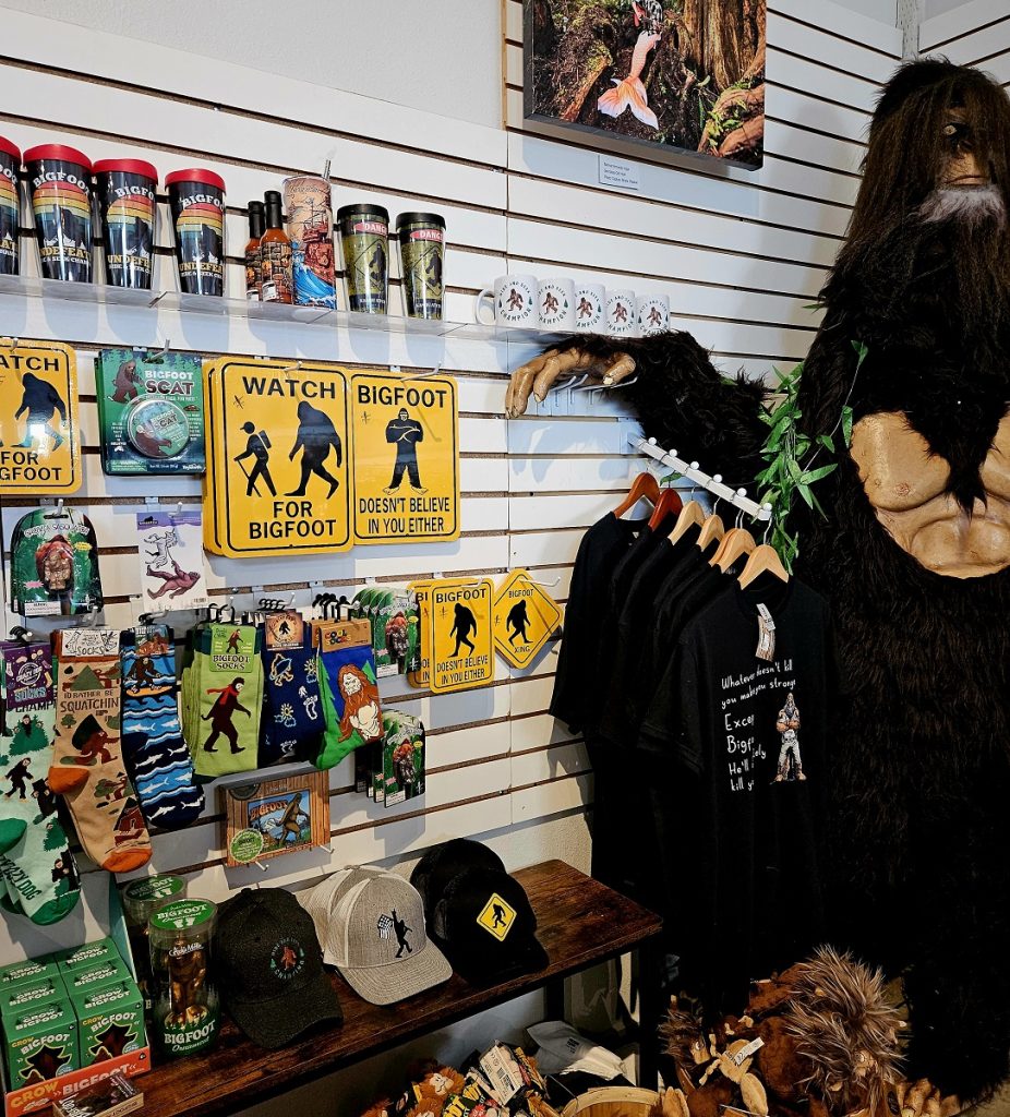life-sized Bigfoot with a bunch of bigfoot gift items including signs, plushies and more