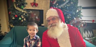 boy sitting with Santa for a photo