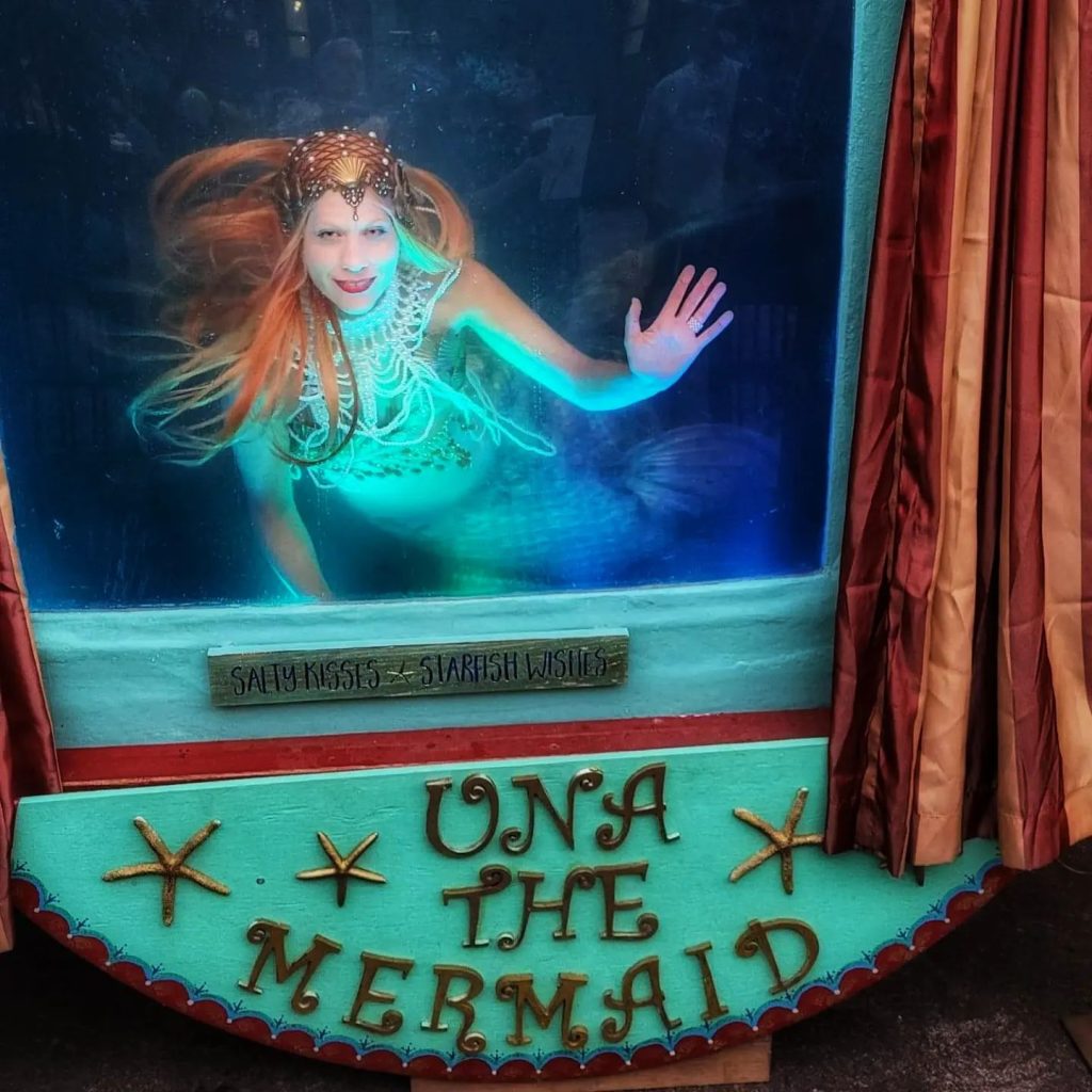 woman dressed as a mermaid in an underwater tank