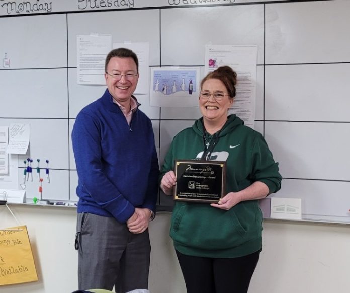 The-Evergreen-State-College-Tammy-Van-Netta-Project-SEARCH Tammy Van Natta and a man stand for a photo, she is holding an award plaque